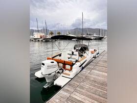 A sleek speedboat docked at a marina, showcasing its modern design and powerful Suzuki engine — perfect for thrilling water adventures.