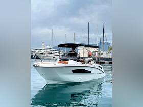 A man navigates a sleek boat in a marina, showcasing the perfect blend of style and functionality for a day on the water.