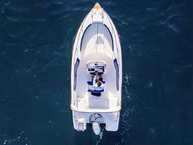 Aerial view of a boat with a person at the helm, showcasing the beauty of the open water and the joy of boating adventures.