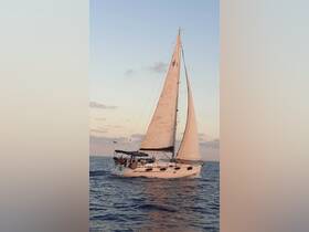 A beautiful sailboat glides through the water at sunset, showcasing a perfect day for sailing adventures.