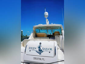 A clear view of the 'Siren Sailor' yacht docked in Destin, FL, showcasing its sleek design and inviting seating area.