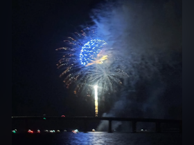 A stunning display of fireworks lights up the night sky, creating a festive atmosphere over the water — perfect for celebrating special occasions.