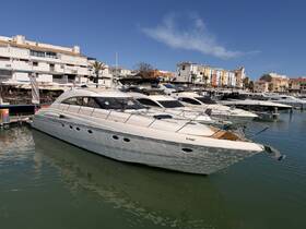 A stunning yacht docked in a marina, showcasing its sleek design and elegant lines against a backdrop of vibrant waterfront buildings.