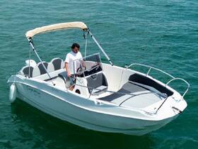 A man navigates a sleek speedboat through clear waters, showcasing the perfect blend of adventure and relaxation on the open sea.