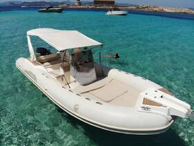 A person enjoys swimming in the crystal-clear waters near a sleek boat, perfect for a day of relaxation and adventure on the water.