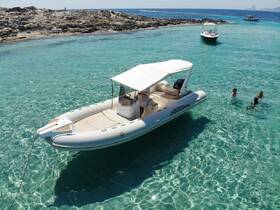 A group enjoys a refreshing swim in crystal-clear turquoise waters near a boat, capturing the essence of a perfect day on the water.