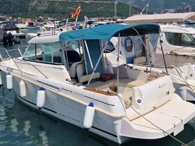 A well-maintained Merry Fisher boat docked in a marina, showcasing its sleek design and inviting seating area, perfect for day trips on the water.