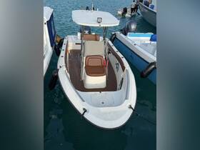 A center console boat docked in clear waters, showcasing its sleek design and comfortable seating — perfect for fishing or day trips.