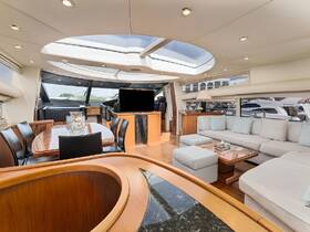 A spacious and elegantly designed interior of a yacht, featuring comfortable seating and a well-equipped helm, perfect for relaxing or entertaining while on the water.