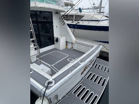 A detailed view of the interior deck of a boat, showcasing the spacious layout and amenities, perfect for relaxation and socializing on the water.