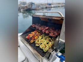 A well-equipped grill on a boat showcases a delicious spread of skewered meats and seafood, perfect for onboard barbecues and gatherings.