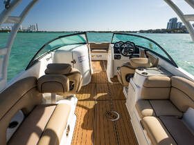 A spacious and well-appointed interior of a boat featuring comfortable seating and a modern helm, perfect for enjoying a day on the water.
