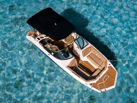 A stunning aerial view of a sleek speedboat gliding over crystal-clear waters, showcasing its elegant design and spacious seating — perfect for a day of adventure on the water.