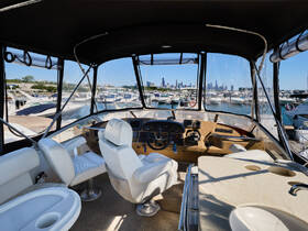 The interior of a well-appointed boat helm showcases comfortable seating and a clear view of the marina, perfect for navigating the waters.