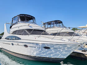 A stunning view of a sleek yacht docked at the marina, showcasing its elegant design and pristine condition against a clear blue sky.