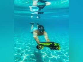 A snorkeler explores the vibrant underwater world, showcasing the thrill of aquatic adventures in crystal-clear waters.