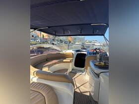 A spacious interior view of a boat's helm and seating area, featuring elegant design and comfortable lounging space, perfect for relaxing on the water.