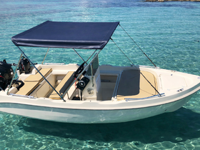 A sleek center console boat anchored in crystal-clear waters, perfect for day trips and exploring coastal destinations.