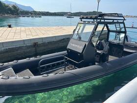 A sleek Highfield boat docked at a serene waterfront, showcasing its robust design and clear turquoise waters — perfect for exploring coastal destinations.