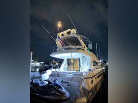 A stunning view of a yacht named 'Four Seasons' docked in Miami at night, showcasing its elegant design and illuminated features.