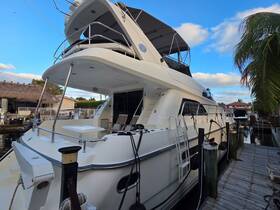 A stunning side view of a luxurious yacht docked along a canal, showcasing its elegant design and spacious deck, perfect for relaxing on the water.