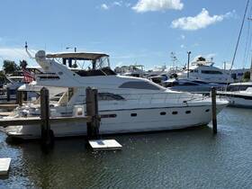 A stunning yacht docked at the marina, showcasing its elegant design against a clear blue sky — perfect for luxury charters and private getaways.
