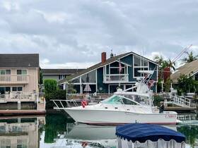 A Cabo fishing boat is seen at the marina, with a person on board, showcasing a serene day on the water.