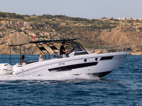 A sleek boat speeds through the water with passengers enjoying the ride, showcasing the perfect blend of adventure and relaxation on the open sea.