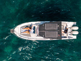 Two friends relax on the deck of a boat under the sun, enjoying a perfect day on the water — ideal for summer outings and group adventures.