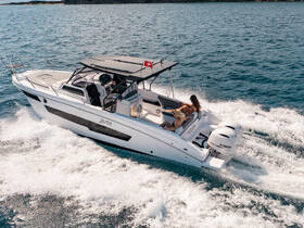 A stylish boat speeds through the water with two women enjoying the ride, showcasing the thrill of a day on the water.