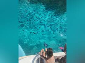 A child prepares to snorkel in crystal-clear waters, showcasing a fun and adventurous day on the boat — perfect for family outings and aquatic exploration.