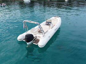 A Tiki boat anchored in clear turquoise waters, showcasing its sleek design and inviting atmosphere for a perfect day on the water.