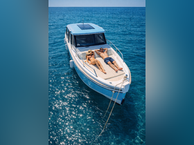 A couple enjoys sunbathing on the deck of a boat in crystal-clear waters, perfect for a relaxing day at sea.