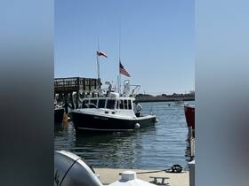 The 'BIG DOG' boat is seen maneuvering in the water, showcasing its sleek design and American flag, perfect for fishing or coastal adventures.