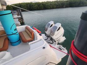 Interior view of a boat showcasing comfortable seating and the helm area, perfect for relaxing while on the water.
