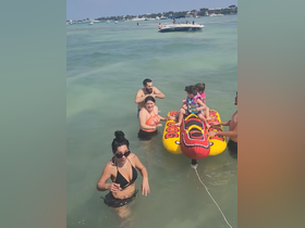 A fun-filled day at the beach with family enjoying water activities on an inflatable banana boat, creating unforgettable summer memories.