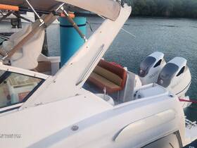 Interior view of a boat's helm and seating area, showcasing comfortable seating and modern design elements, perfect for a day on the water.