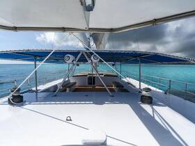 A stunning view of a catamaran's deck, showcasing its spacious layout and beautiful turquoise waters, perfect for a relaxing day on the sea.