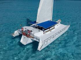 A stunning aerial view of a sleek catamaran gliding through crystal-clear turquoise waters, perfect for luxury charters and island adventures.