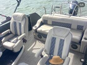 A well-appointed interior view of a boat featuring comfortable seating and a stylish helm, perfect for relaxing on the water.