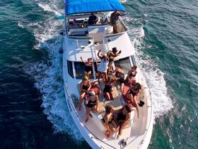 A lively group enjoys a fun day on the water aboard a boat, celebrating with friends and soaking up the sun.