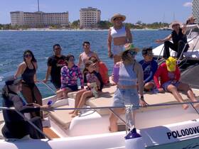 A lively group enjoys a fun day on the water, celebrating aboard a boat with friends — perfect for memorable outings and adventures.
