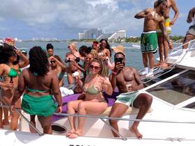 A lively group of friends enjoys a fun day on the water, celebrating together on a boat — perfect for summer parties and unforgettable memories.