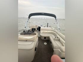 Interior view of a spacious boat cabin featuring comfortable seating and a helm, perfect for relaxing on the water.
