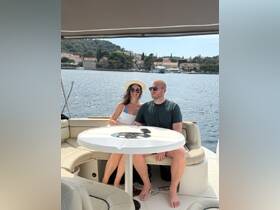 A couple enjoys a relaxing moment aboard a boat, surrounded by scenic views — perfect for romantic getaways or leisurely days on the water.