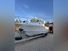 A sleek speedboat is showcased on its trailer, set against a clear blue sky, perfect for fishing trips or weekend getaways on the water.