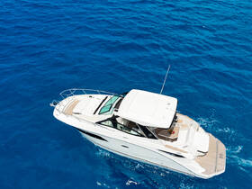 A stunning aerial view of a sleek yacht cruising through vibrant blue waters, perfect for luxury charters and ocean adventures.