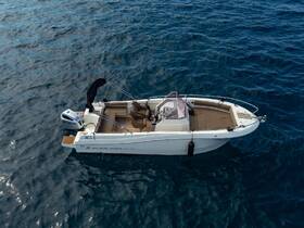 Aerial view of a sleek Atlantic Marine boat cruising through clear blue waters, showcasing its elegant design and spacious seating.