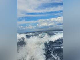 A view of the ocean with waves and clouds, but the image lacks clarity and focus.
