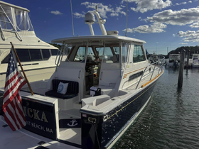 A beautiful side view of a yacht docked at the marina, showcasing its elegant design and American flag, perfect for luxury boating experiences.